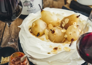 Pavlova with poached pears and caramel