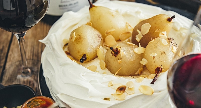 Pavlova with poached pears and caramel